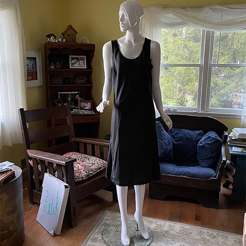 white mannequin dressed in black sheath