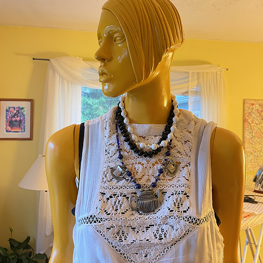 mannequinn dressed and jewelry, including teapot necklace