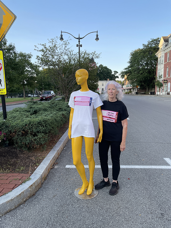 Artist and mani standing on village street