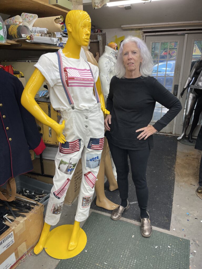 Mannequin dressed and ready for exhibit stands next to artist